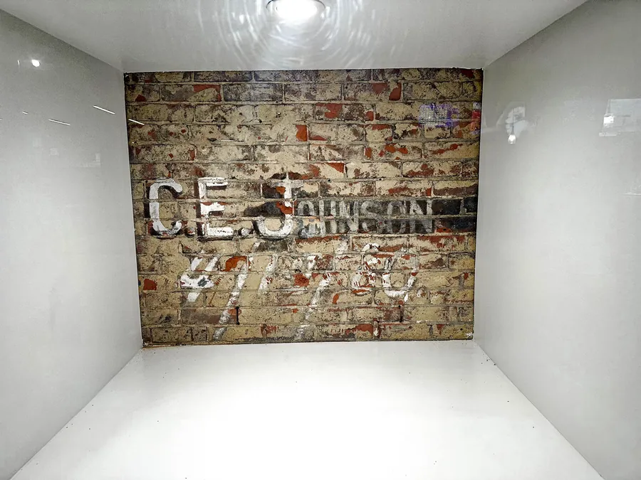 The C.E. Johnson signature, dated 4/10/80, uncovered beneath the plaster during restoration